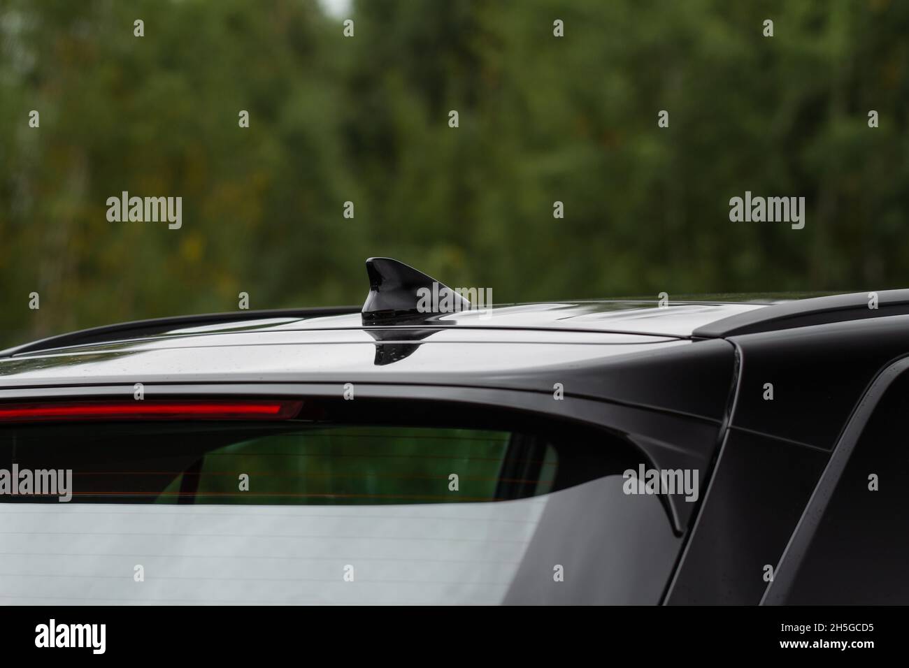 Modern car radio antenna. Shark fin antenna. Modern car roof Stock Photo -  Alamy