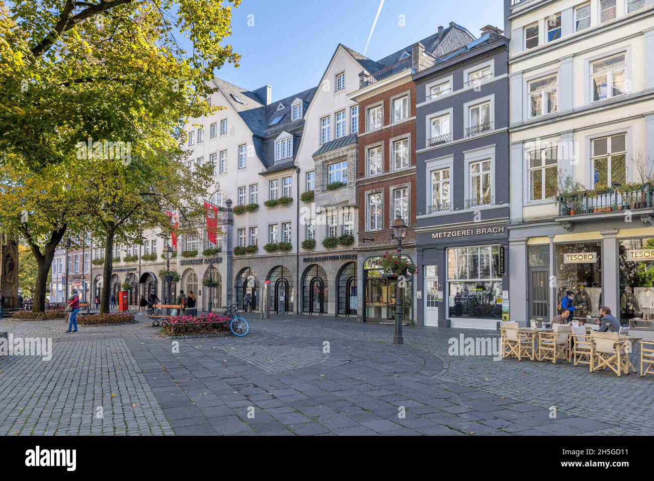 Narrow streets in Aachen old town with incidental people walking by Stock Photo