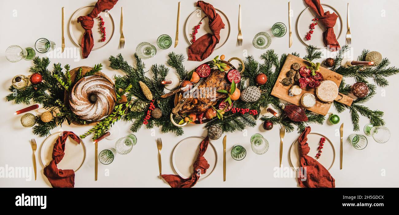Flat-lay of Festive Christmas table setting over white background Stock Photo