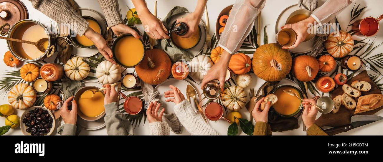 Family eating at Thanksgiving celebration party table Stock Photo