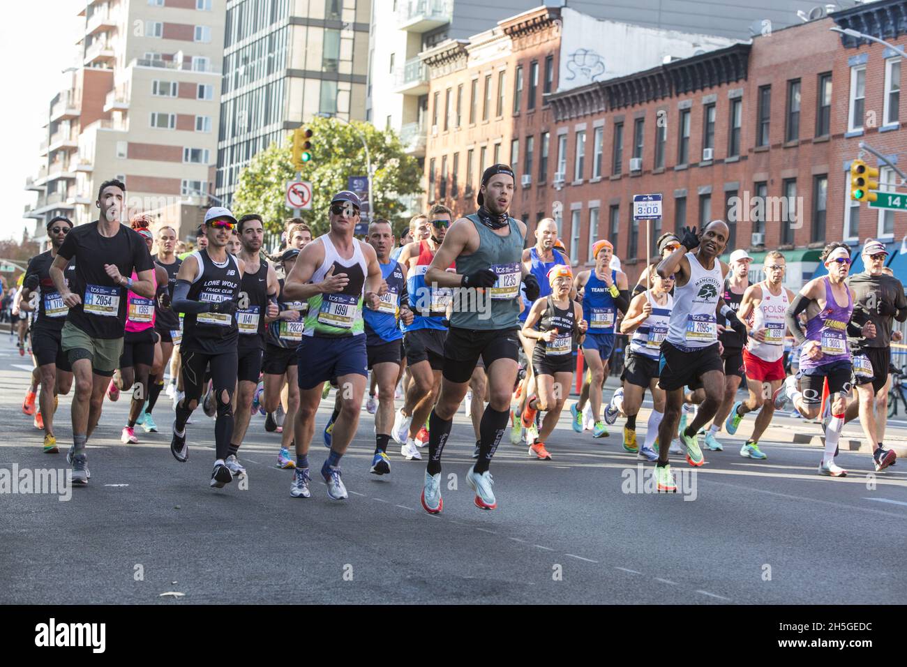 50th anniversary New York City Marathon race in 2021 after no race in 2020 do to the Covid-19 Pandemic. Large pack of runners run with a pace setter up 4th Avenue around mile 6 of the race in Brooklyn. Stock Photo