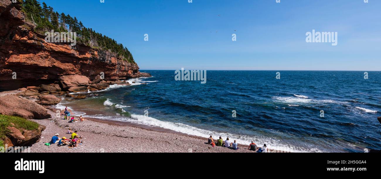 People enjoying the beach on Bonaventure Island; Quebec, Canada Stock Photo