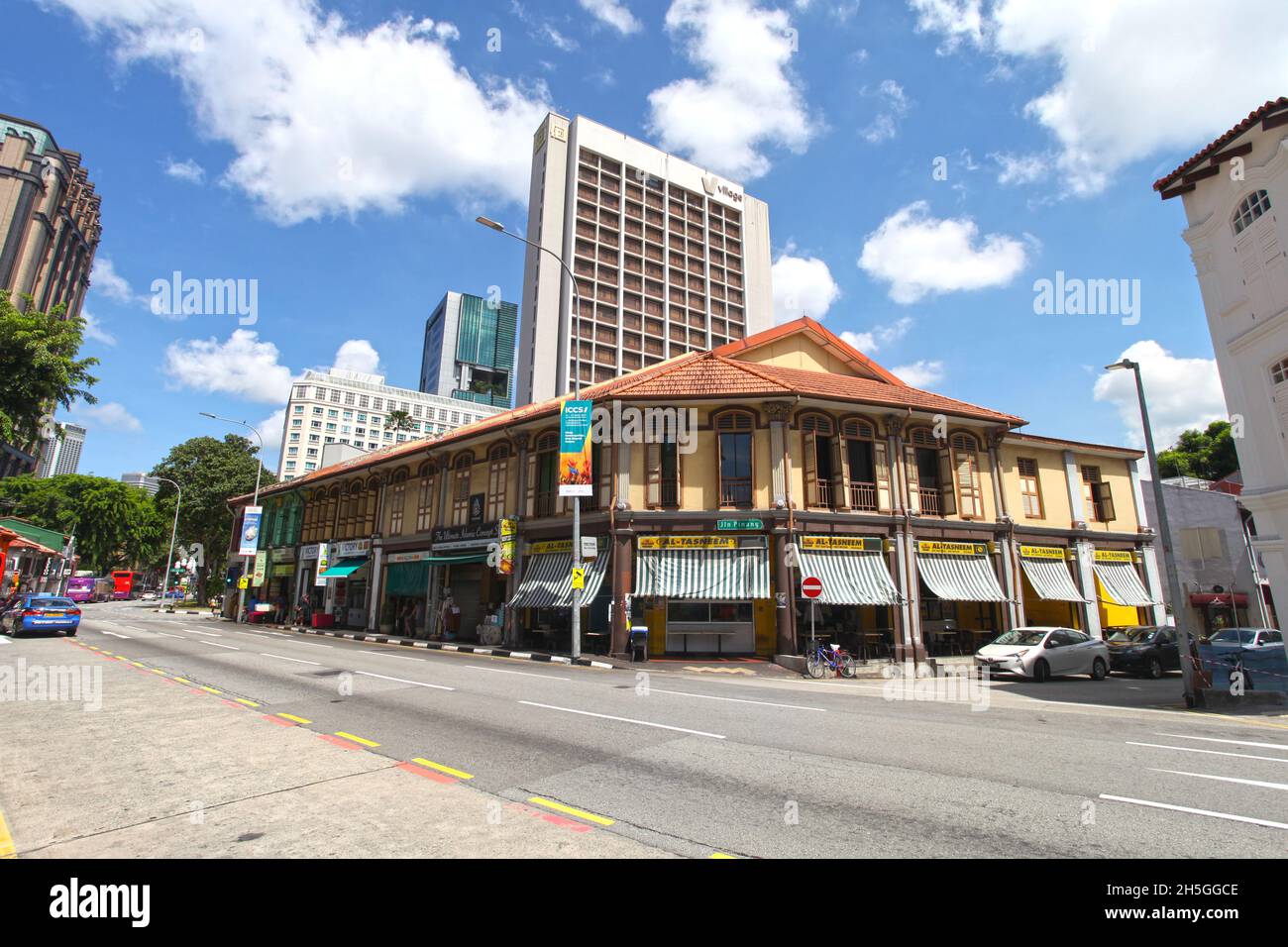Old shophouses on North Bridge Road opposite the Sultan mosque with restaurants selling Indian Muslim food and modern buildings in the background. Stock Photo