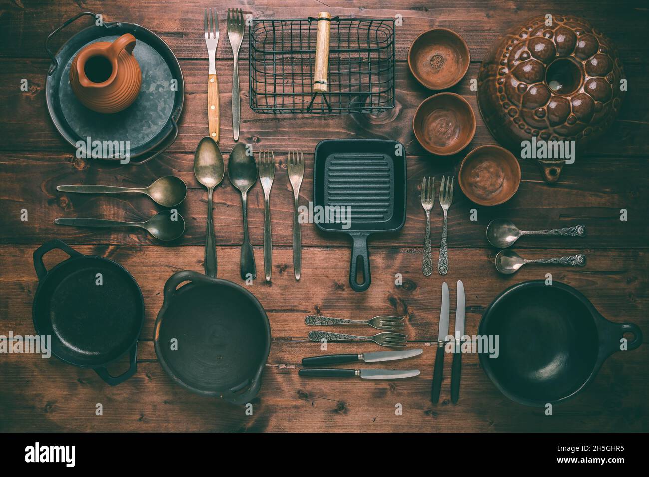 https://c8.alamy.com/comp/2H5GHR5/assortment-of-vintage-kitchen-utensils-on-wooden-table-2H5GHR5.jpg