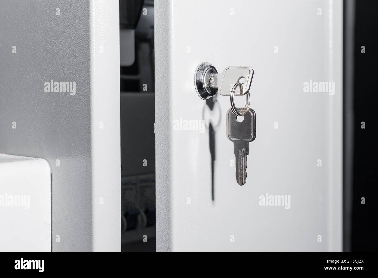Metal key in the socket connector of the electrical box. Safety and technologies of electrical equipment. Stock Photo