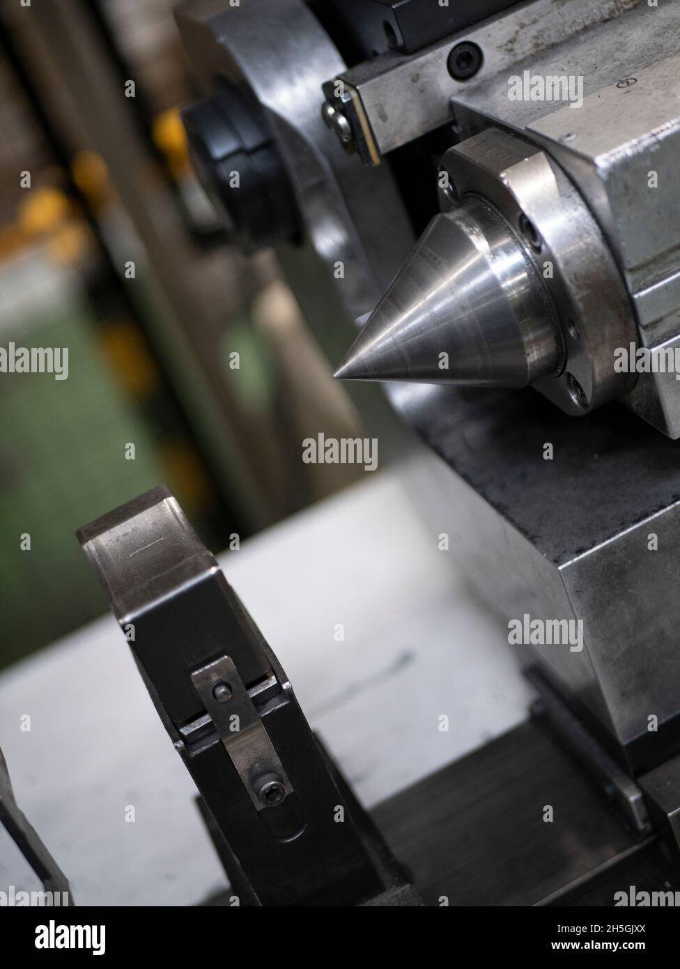 The tailstock of a lathe, close up. Processing of parts. Manufacturing equipment Stock Photo