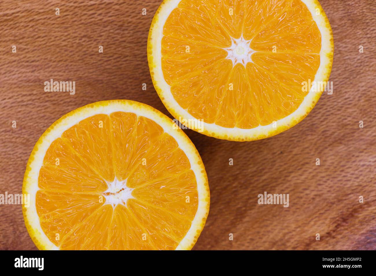 Valencia Orange Fruit Slices Abstract Layout On Wood (Citrus x sinensis) Stock Photo