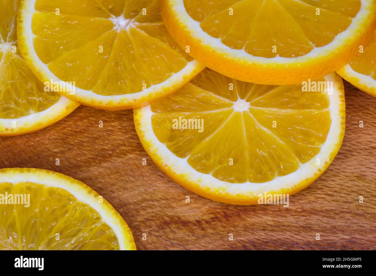 Fresh Valencia Orange Fruit Slices Abstract Layout On Wood (Citrus x sinensis) Stock Photo
