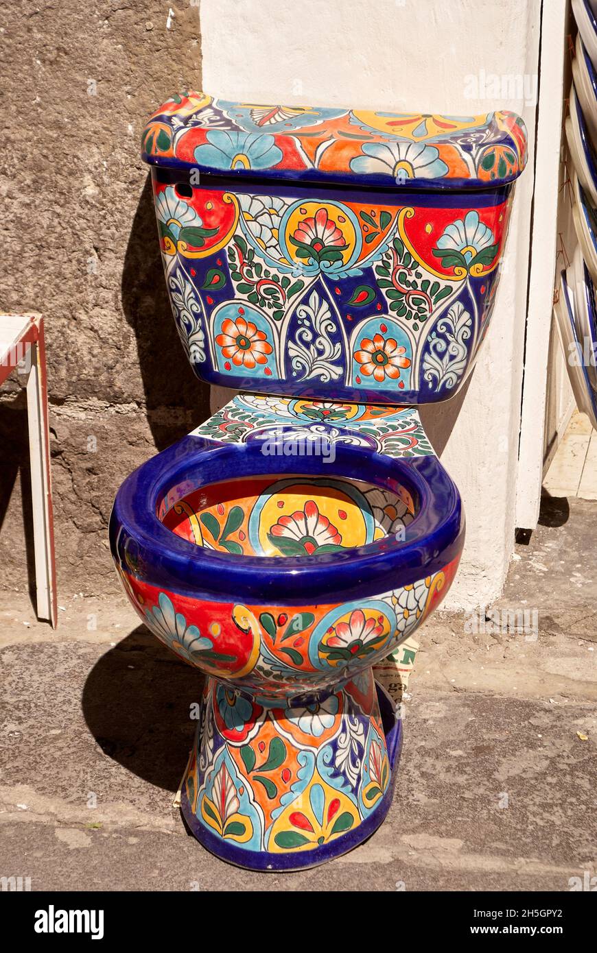 Brightly painted toilet for sale at El Parian handicrafts market in the city of Puebla, Mexico, Mexico. Stock Photo