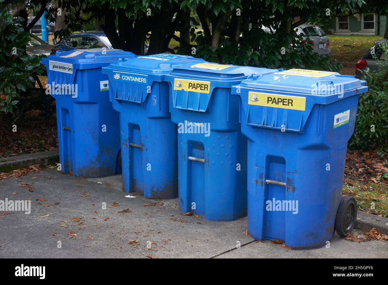 A row of plastic blue recycling bins in Vancouver, British Columbia, Canada Stock Photo