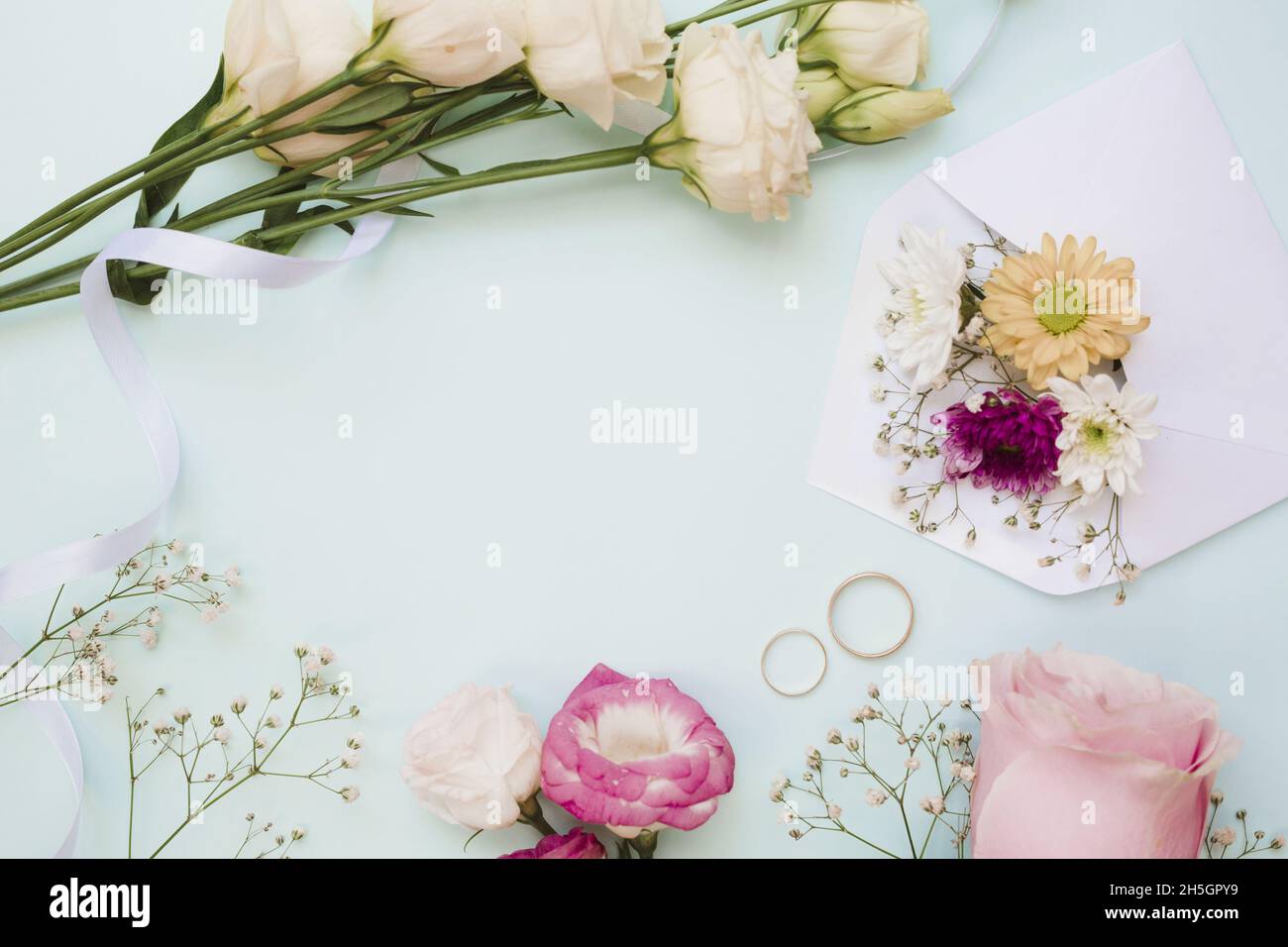 wedding rings flower decoration blue pastel background. Resolution and high  quality beautiful photo Stock Photo - Alamy, image size:1300x956