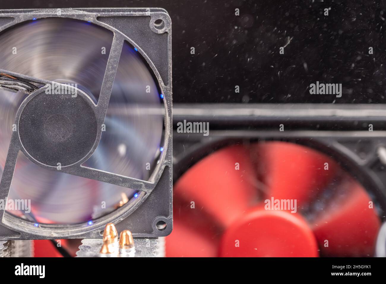 spinning 90 mm pc fan closeup with thick layer of dust and flying
