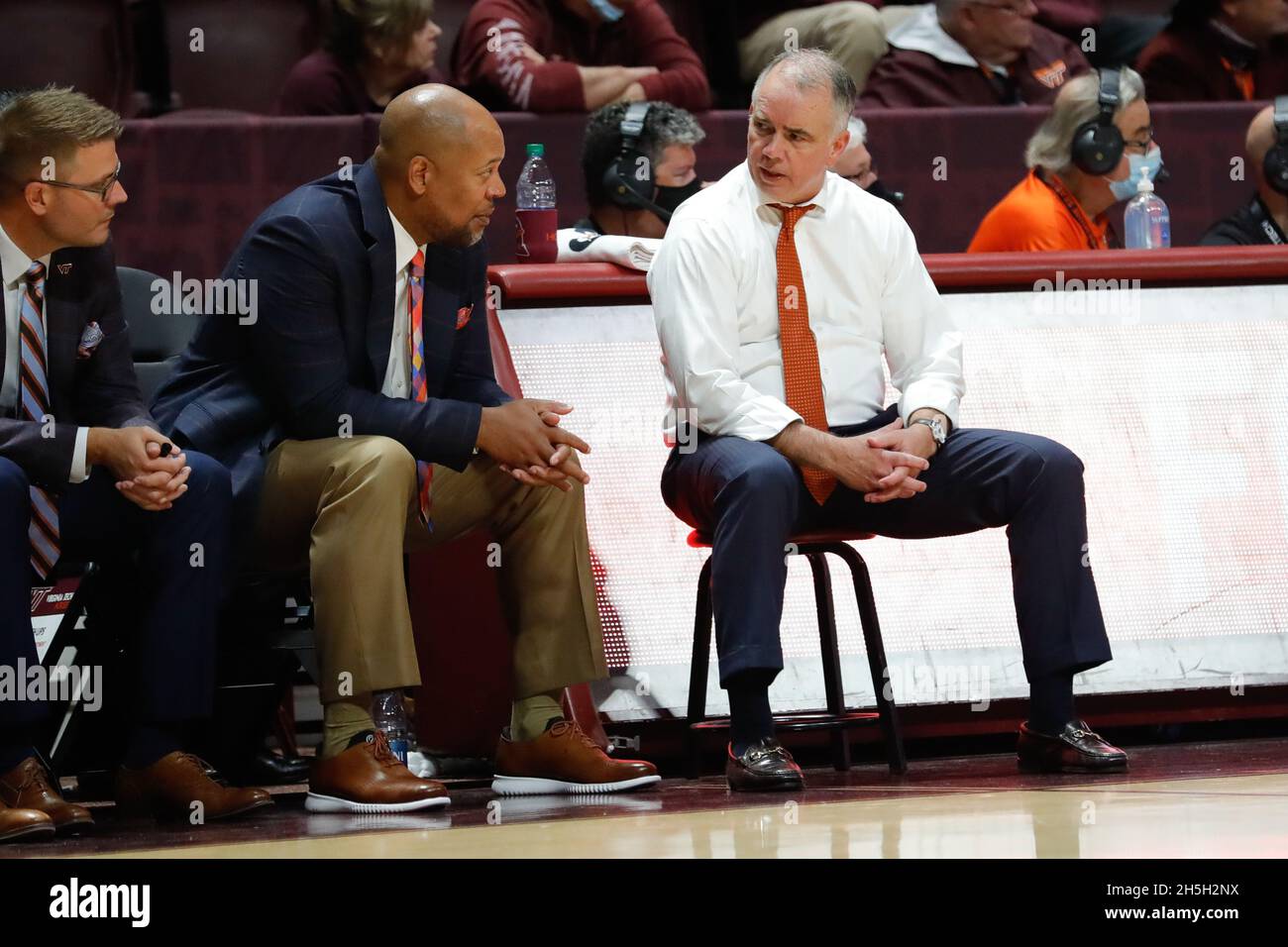 Blacksburg, Virginia, USA. 09th Nov, 2021. Virginia Tech Hokies head coach  Mike Young and assistant coach Mike Jones on the bench during the NCAA  basketball game between the Maine Black Bears and