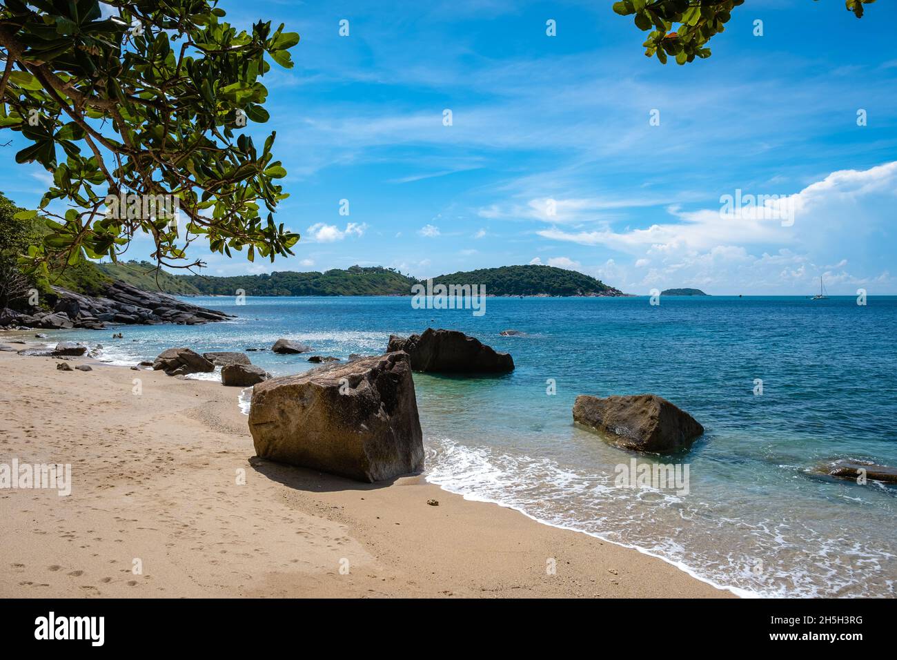 Ao Sane Jungle beach Phuket Thailand, beach with rocks and blue ocean in Phuket Thailand Stock Photo