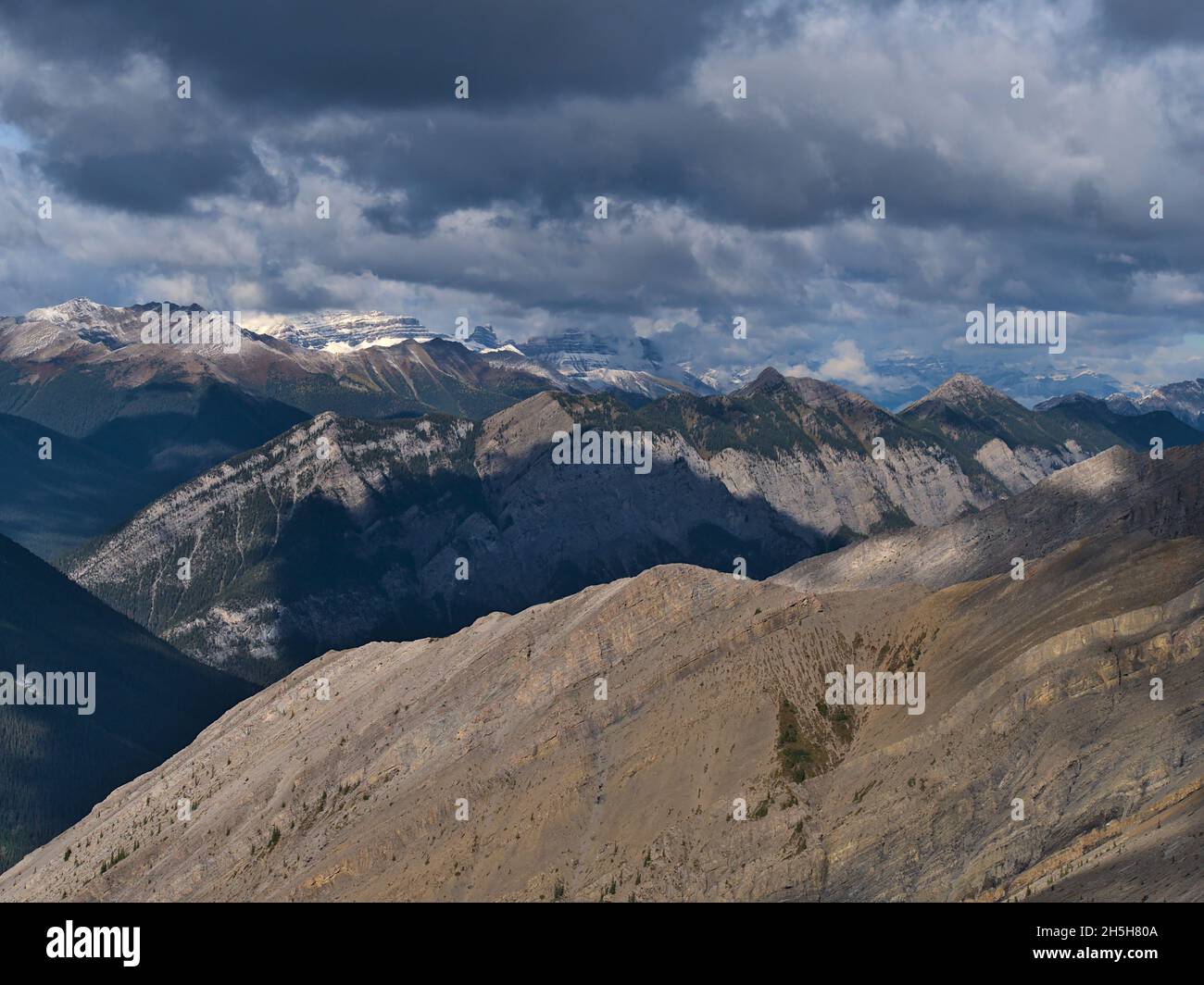 Stunning view over the rough Rocky Mountains near Canmore, Kananaskis Country, Alberta, Canada with the snowy peaks of Sundance Range. Stock Photo
