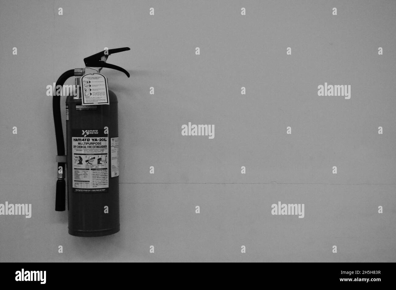emergency fire extinguisher in black and white photo Stock Photo