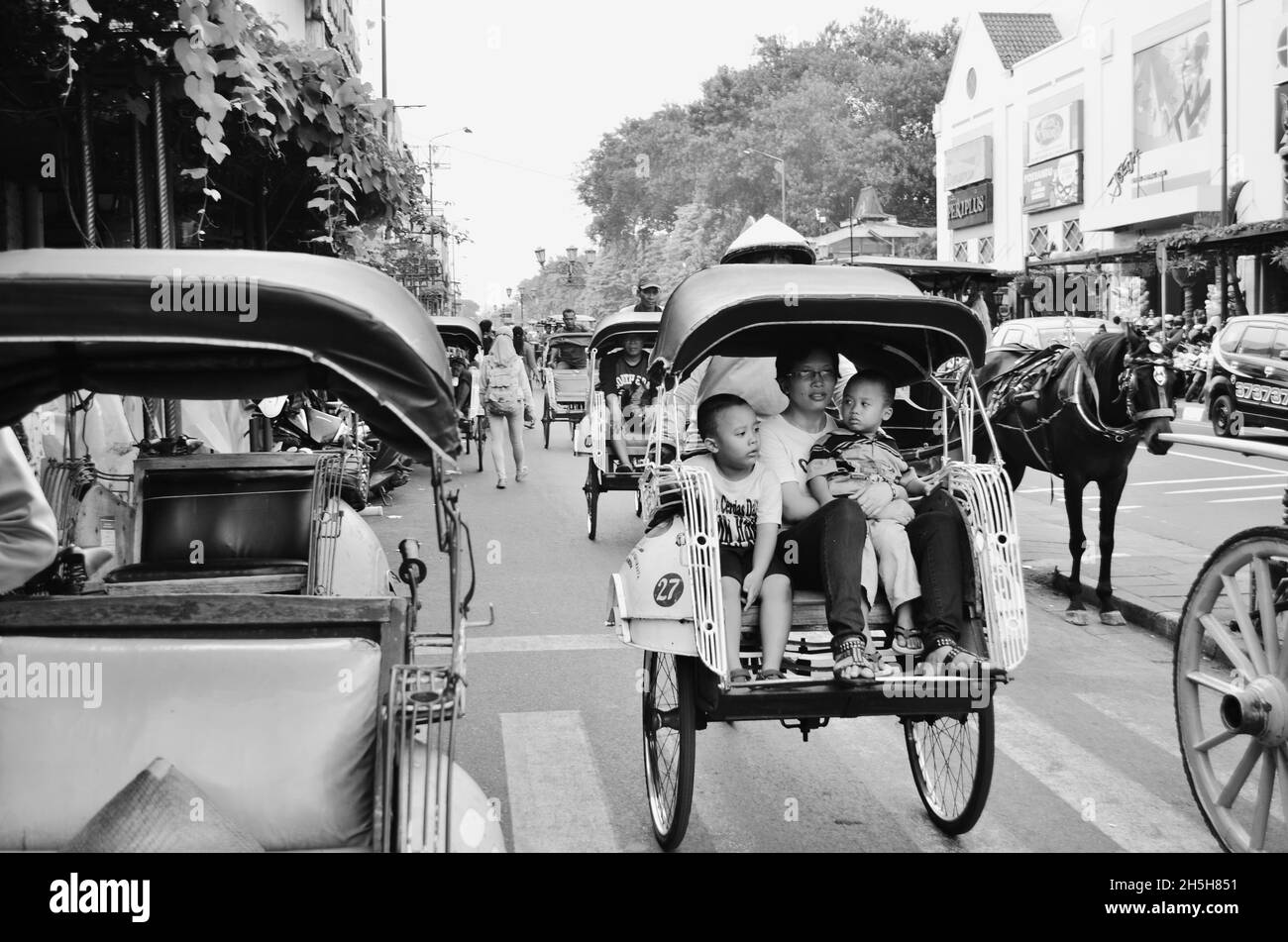 traditional rickshaw passenger and driver, Jalan Malioboro, Yogyakarta, Indonesia Stock Photo