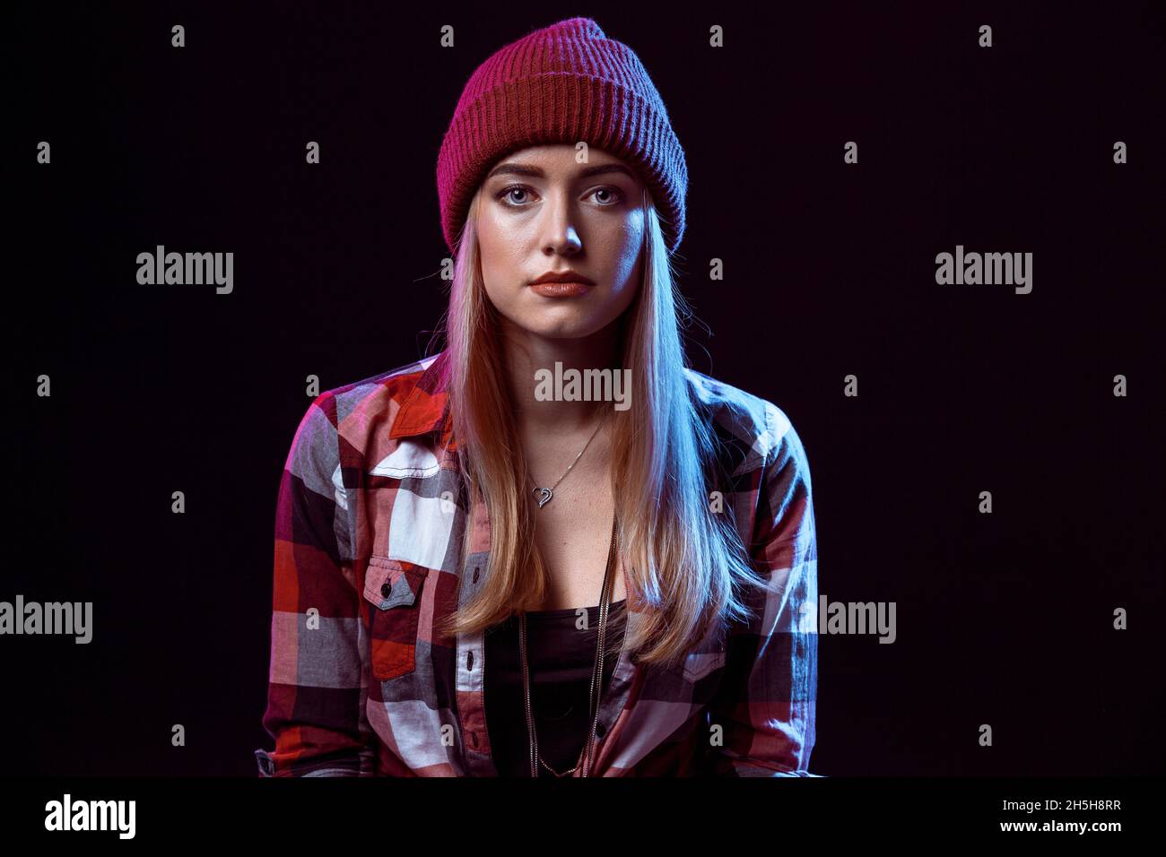 Charming casual girl, wearing in red and black plaid shirt hat on a background Stock Photo