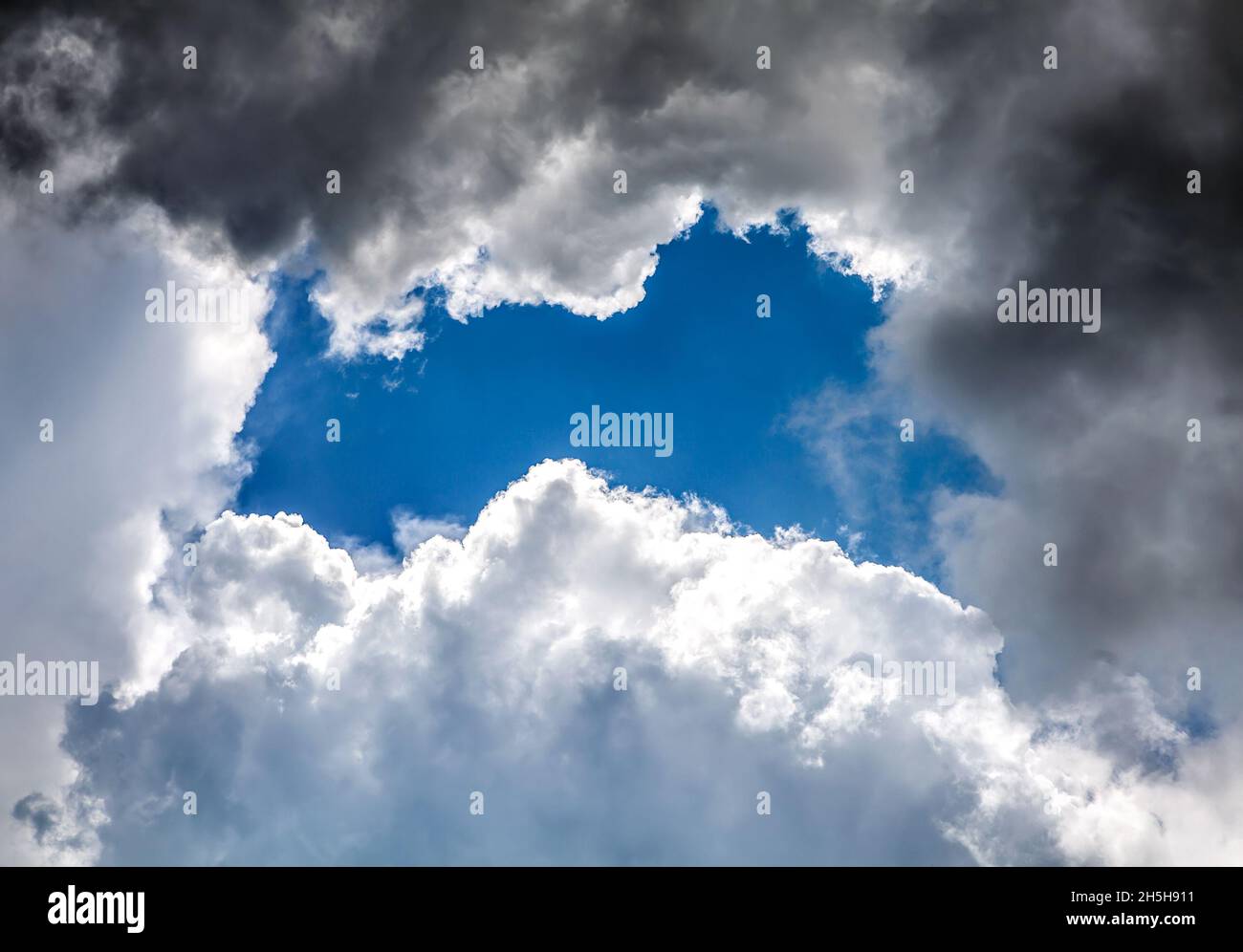 Dramatic Cloudscape Background with Hole of Blue Sky Stock Photo - Alamy