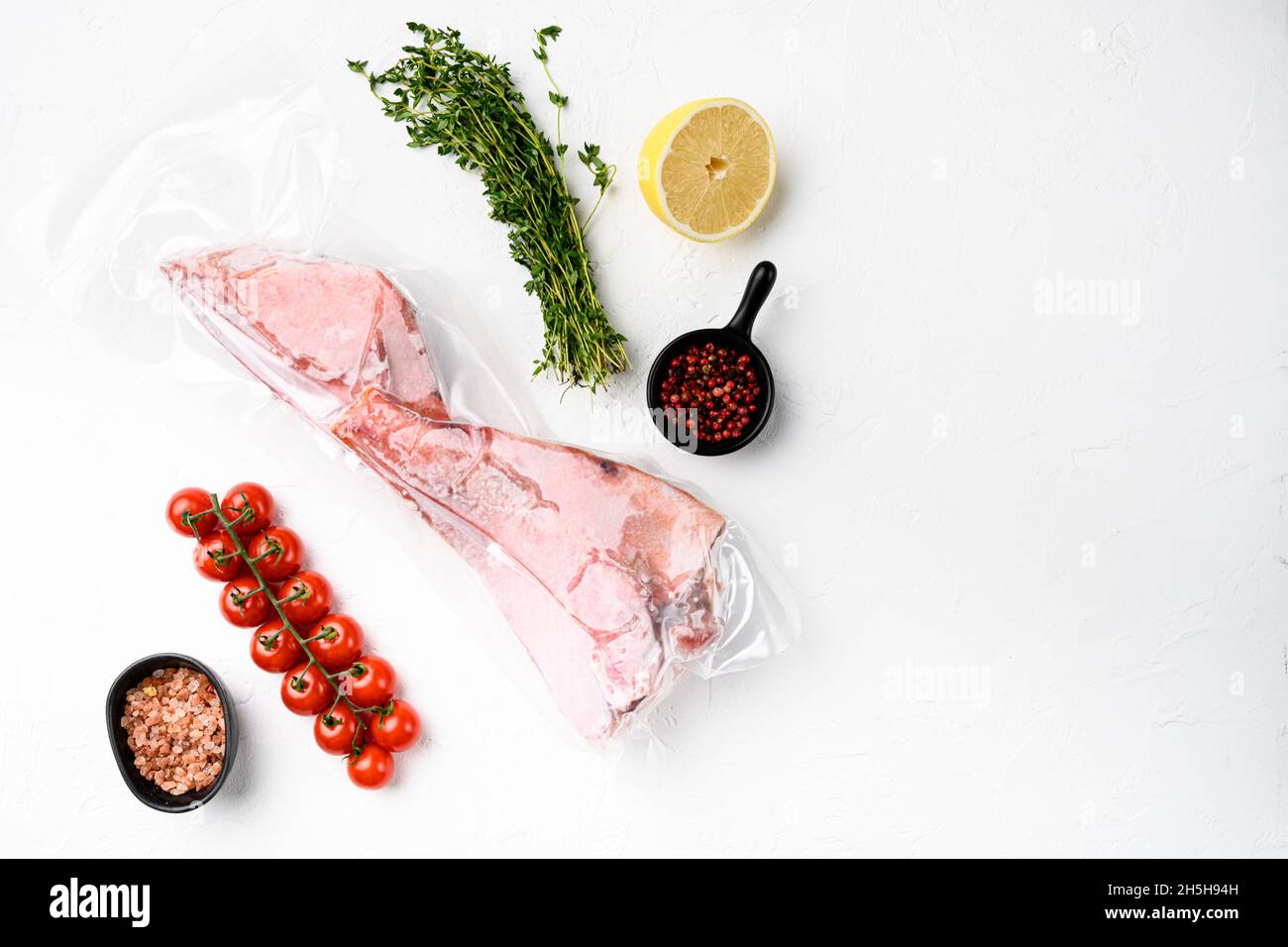 Red Snapper frozen pack fish meat set, with herbs, on white stone table ...