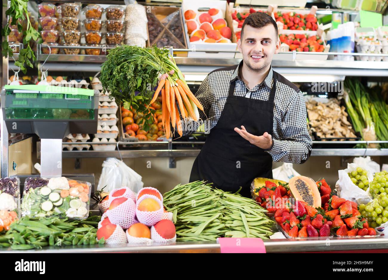 shopping assistant demonstrating assortment of grocery shop Stock Photo