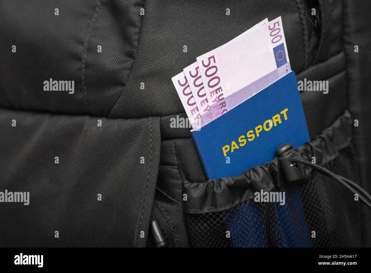 A backpack from whose pocket a passport and money are sticking out in euros.  Concept of travel Stock Photo