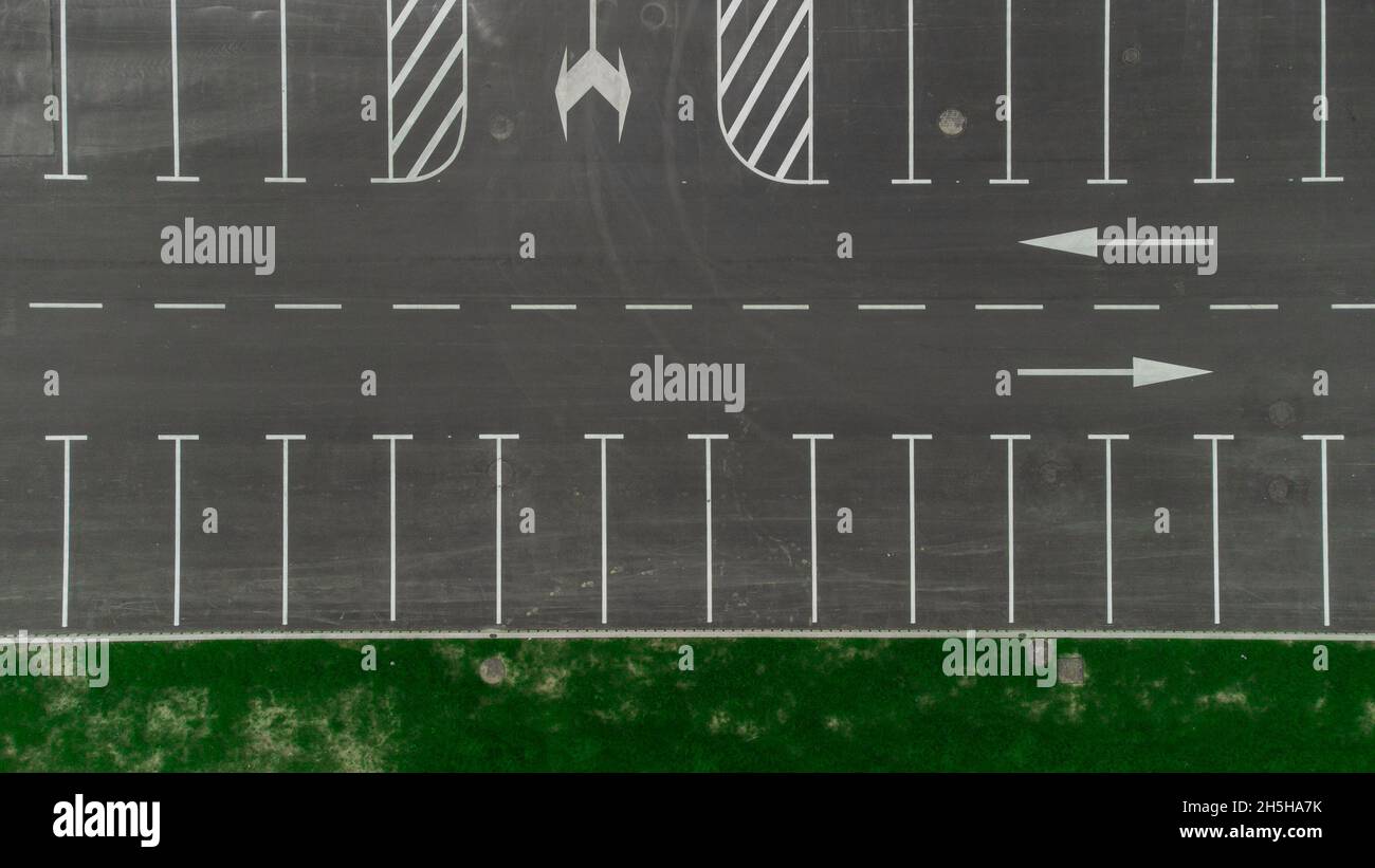 Different lines on a parking lot. PArking spaces and routes with markings or arrows visible from above. Stock Photo