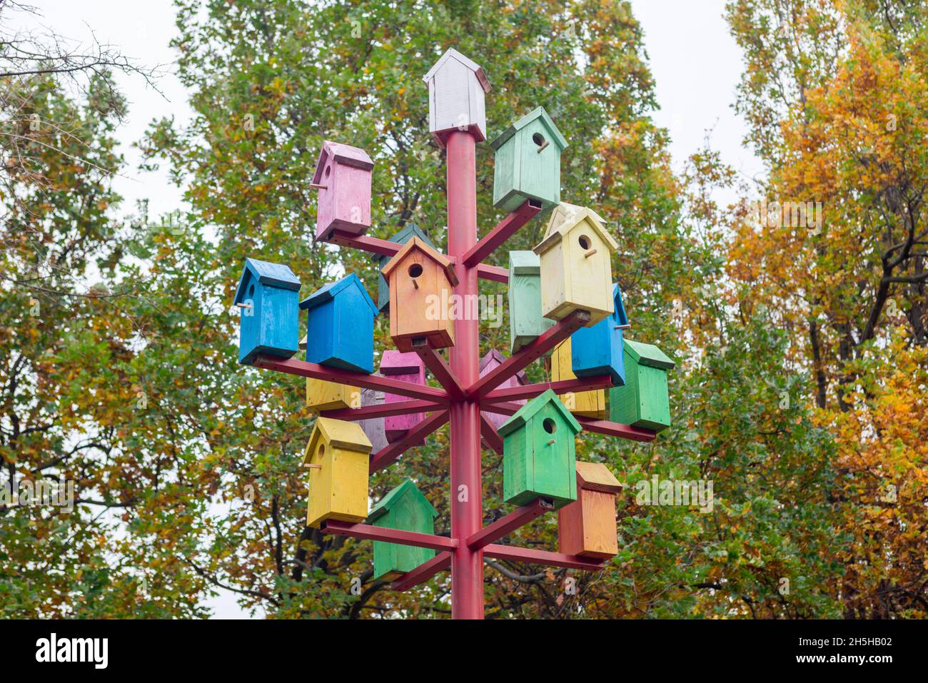 A lot of colorful birdhouses. Colorful birdhouses in the park. Life in the neighborhood. Nesting season Stock Photo