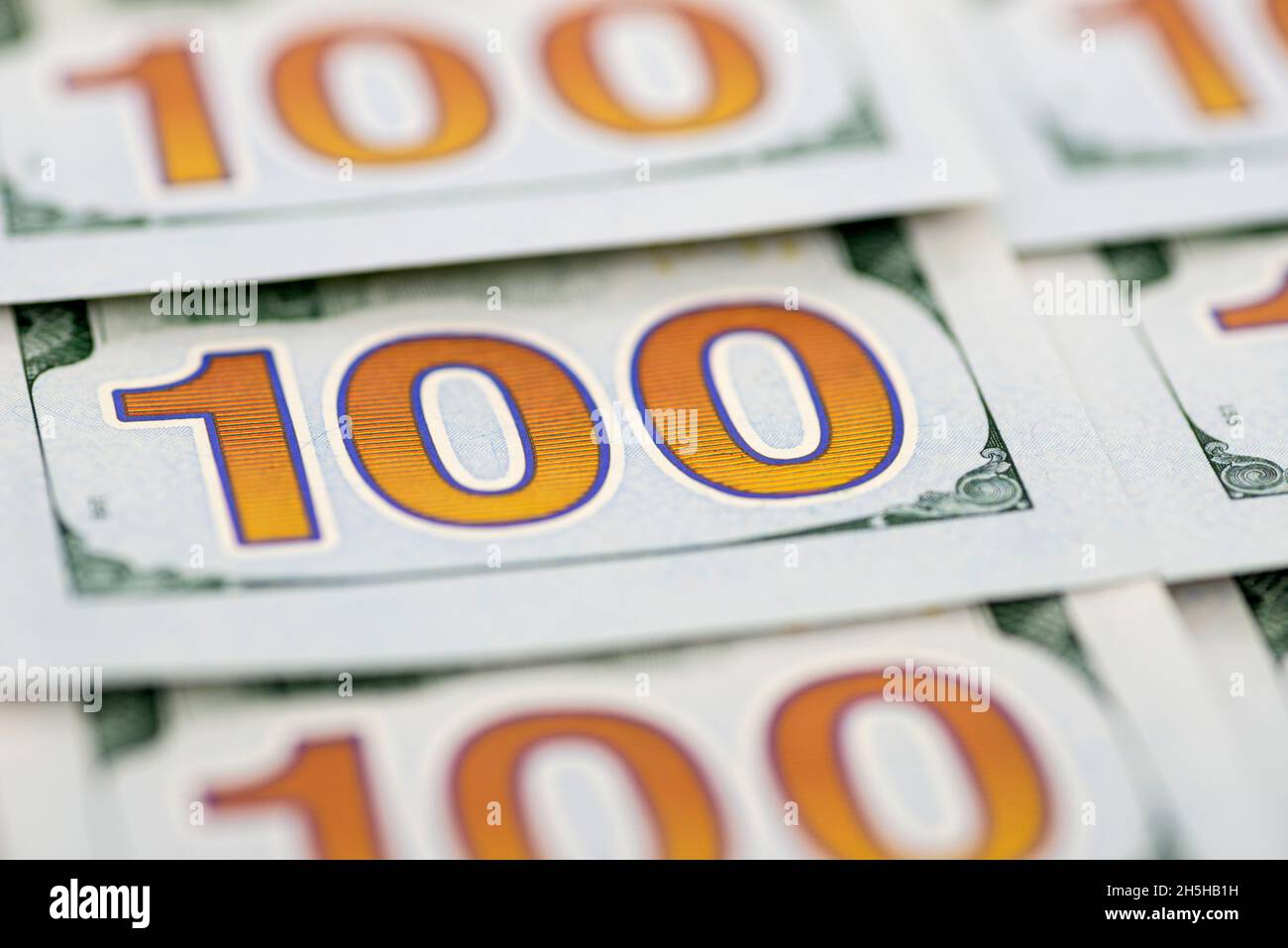 A pile of one hundred dollar bills as background. Pile of one hundred dollar bills new design. Background of 100 new dollar bills Stock Photo