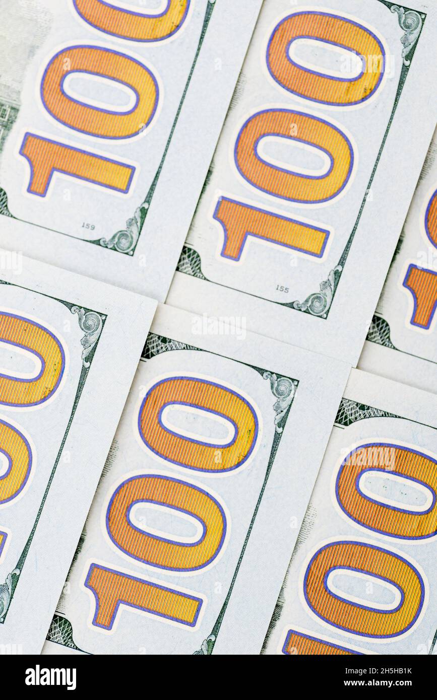 A pile of one hundred dollar bills as background. Pile of one hundred dollar bills new design. Background of 100 new dollar bills Stock Photo