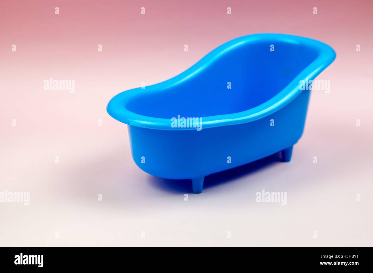 Blue plastic bathtub on a pink background. Toy bath Stock Photo - Alamy