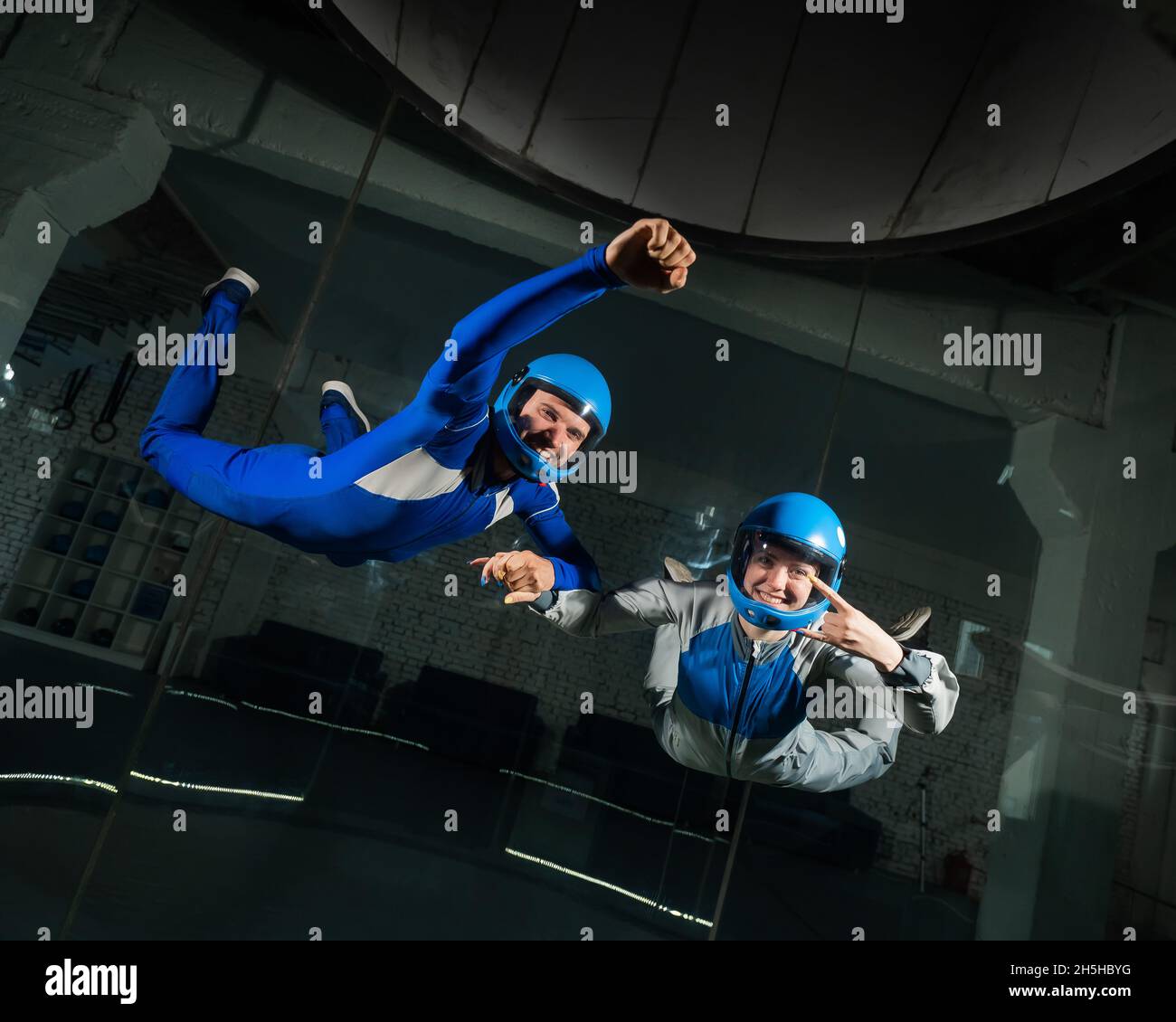 A man and a woman enjoy flying together in a wind tunnel. Free fall ...