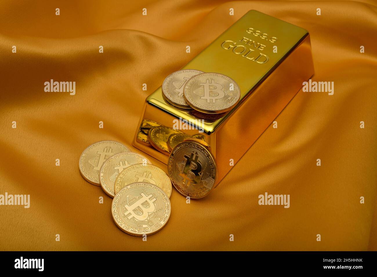 Gold bar fine gold fineness 999.9 and Bitcoin cryptocurrency, Baden-Wuerttemberg, Germany Stock Photo