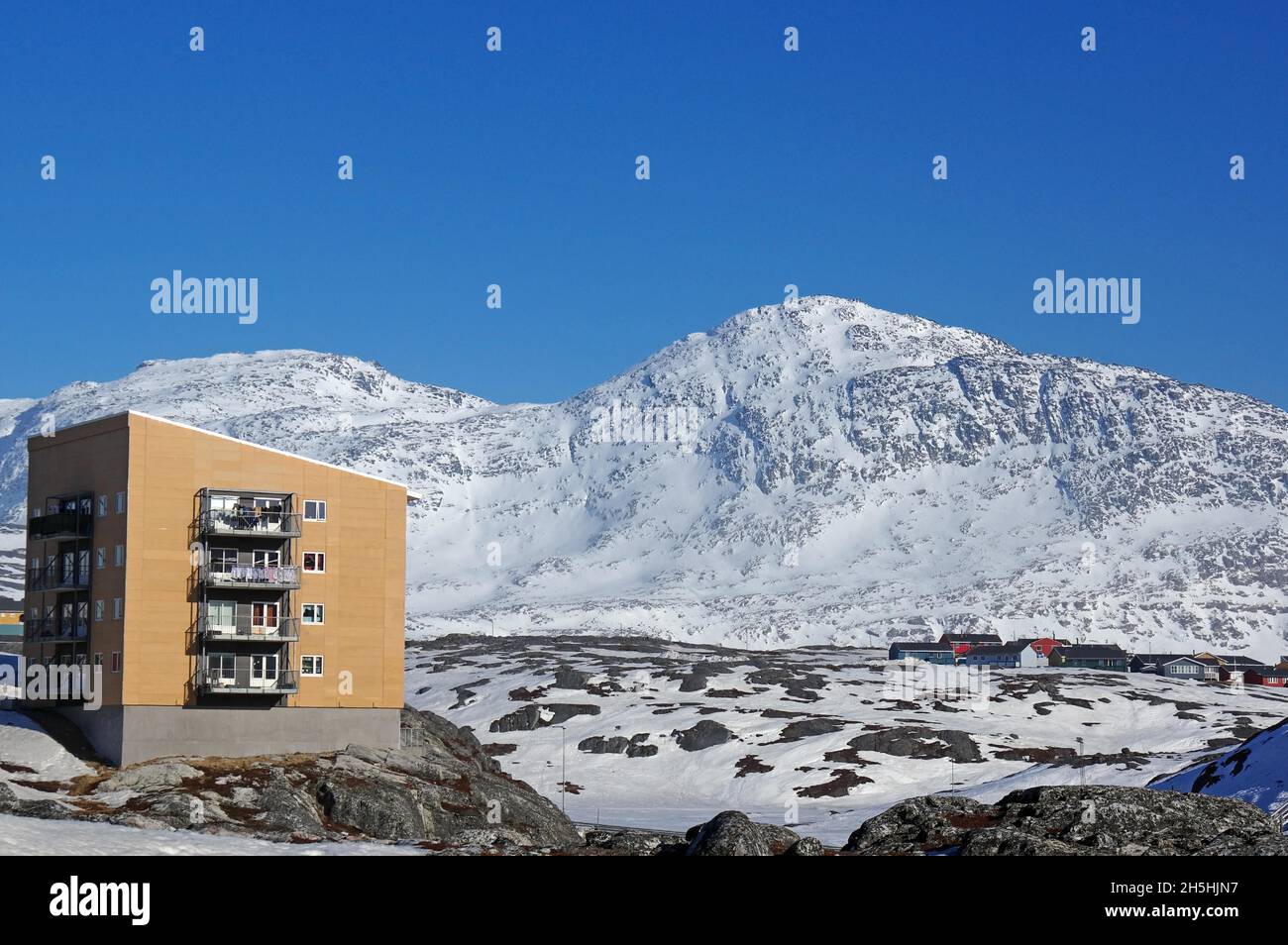 Modern apartment block and rocky winter landscape, capital