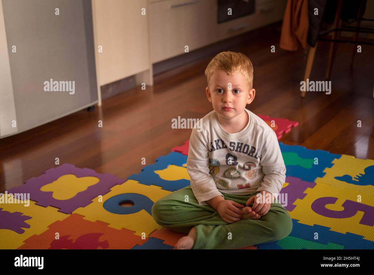 Cute creative and curious little boy playing with his toy's Stock Photo