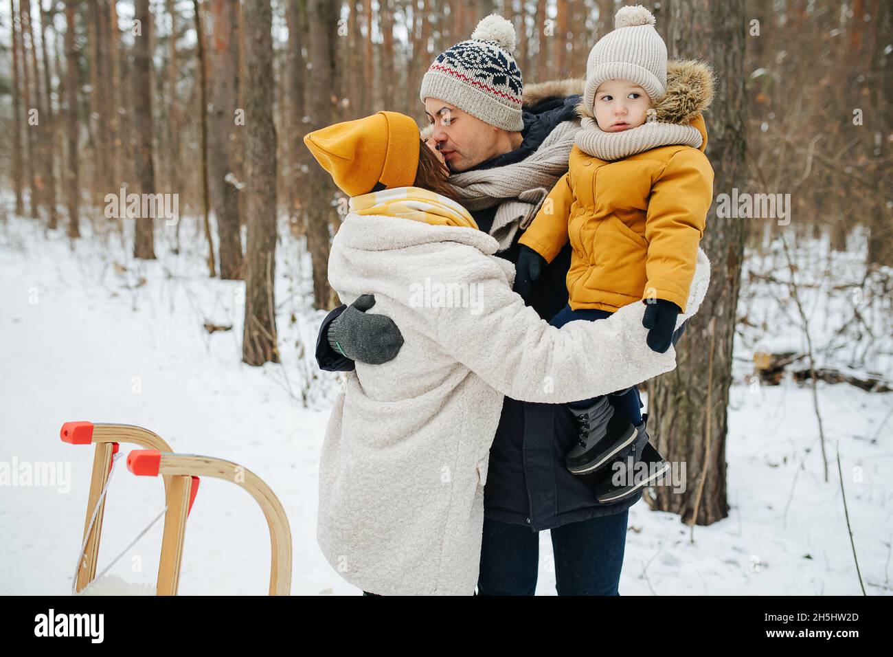 Family walks in the winter forest at Christmas eve Stock Photo