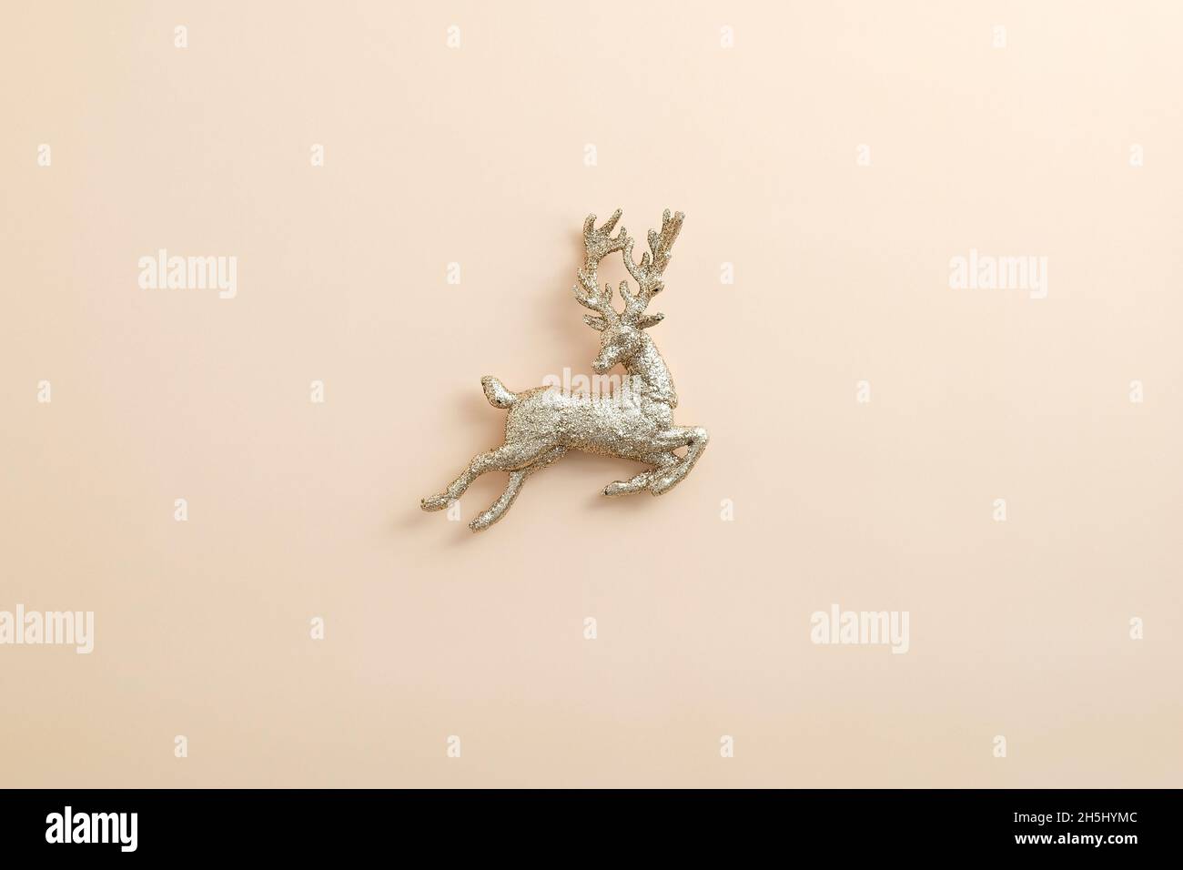 Christmas golden reindeer decoration on pastel beige background. Flat ...
