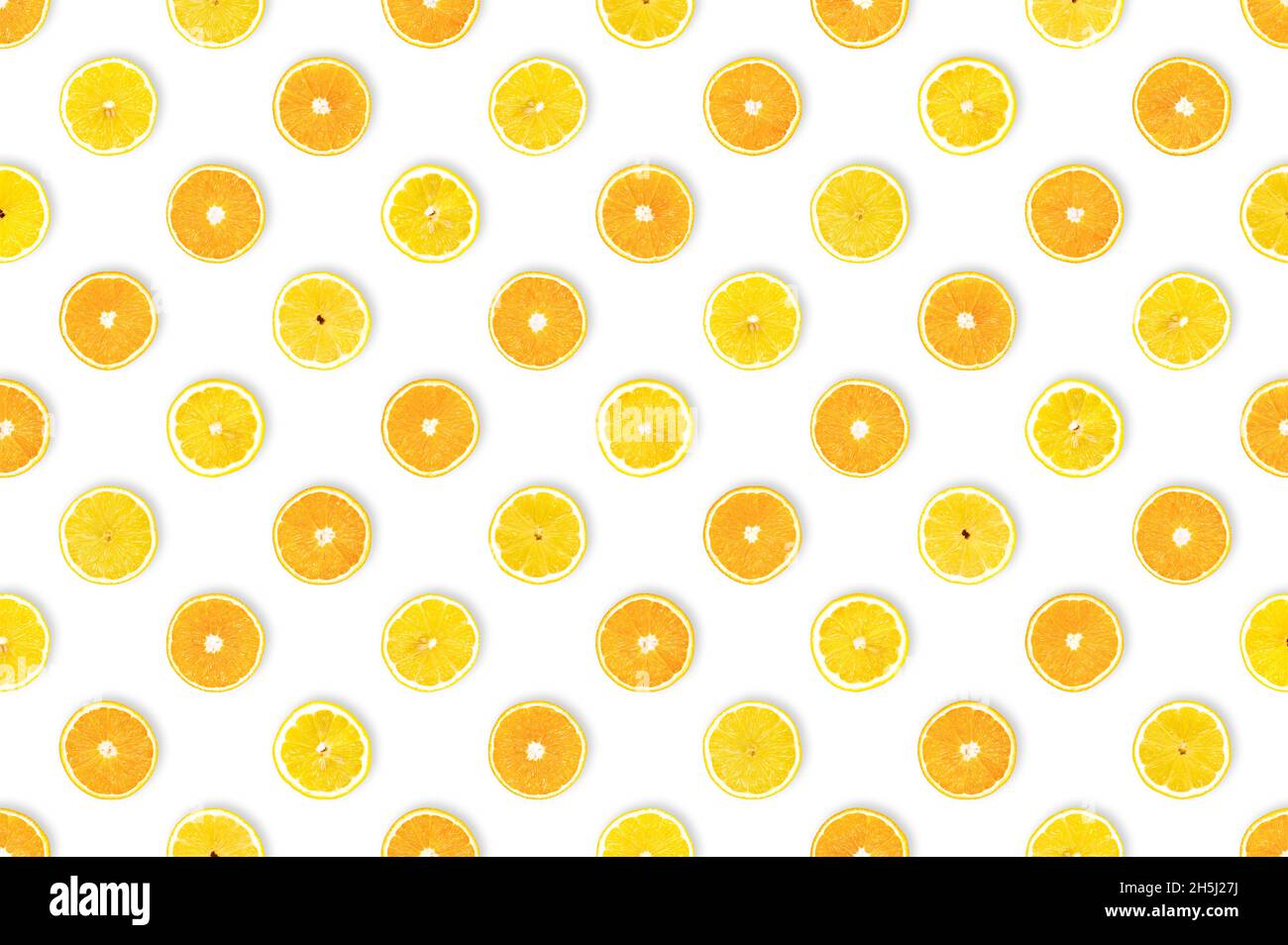 Sweet meets sour: healthy diet concept. Fruit with important nutrients. Pattern of freshly cut lemon and orange slices against white background. Stock Photo