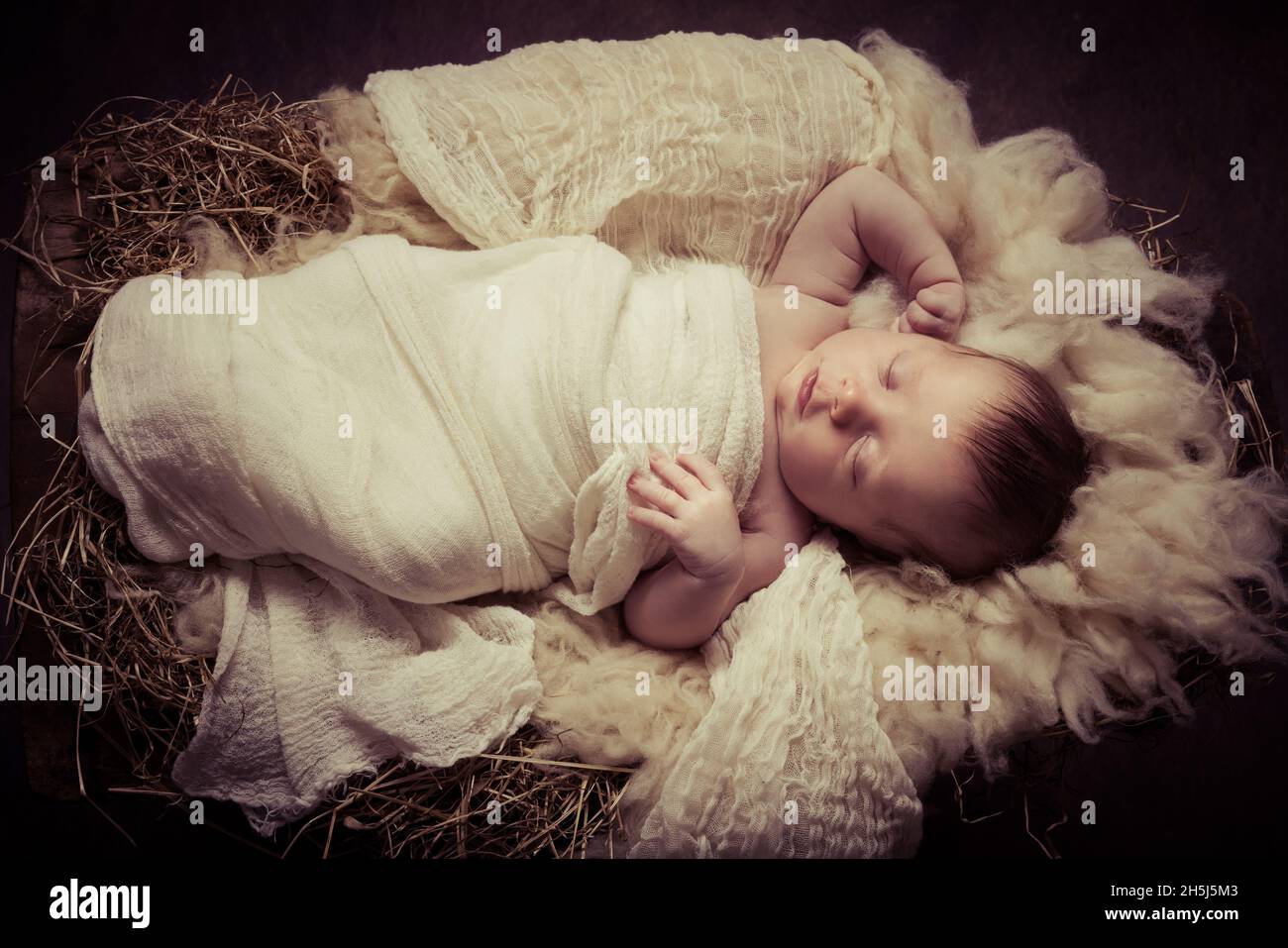 Live Christmas nativity scene with the real parents of a 9 days old