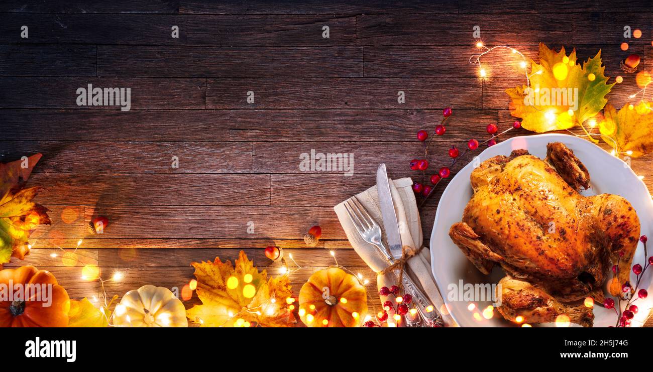 Turkey - Thanksgiving Celebration - Table Setting With Silverware And Autumnal Decoration On Wooden Plank Stock Photo