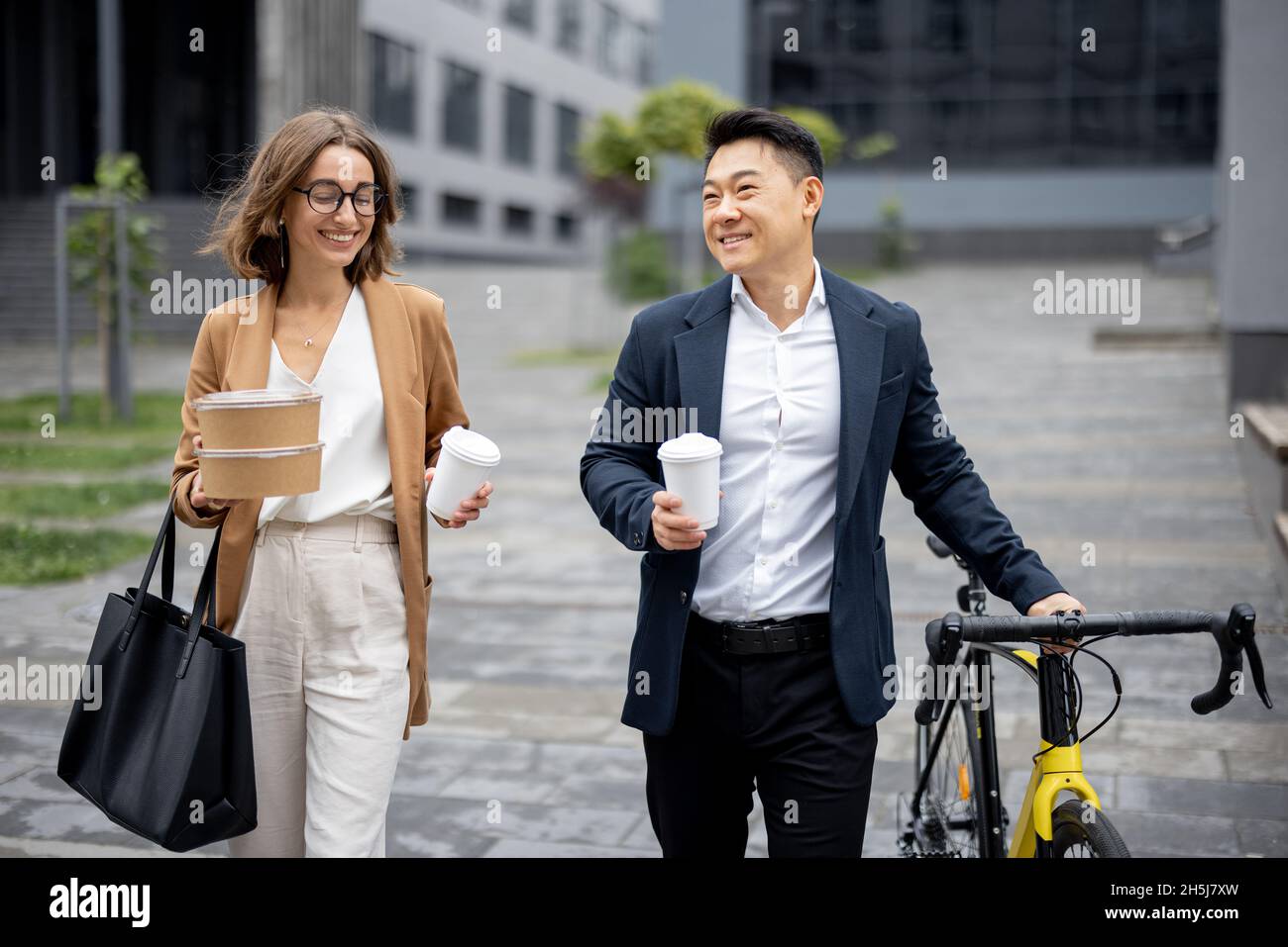 Business people walk, drink coffee and talk Stock Photo Alamy
