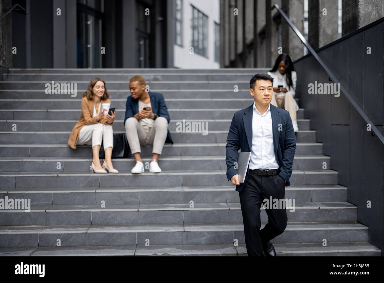 Business team talking and using digital devices Stock Photo