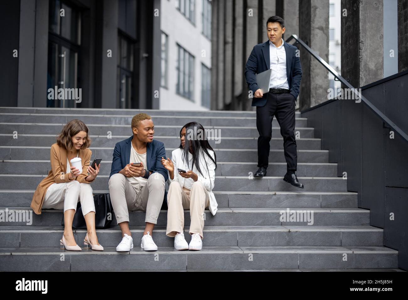 Business team talking and using digital devices Stock Photo