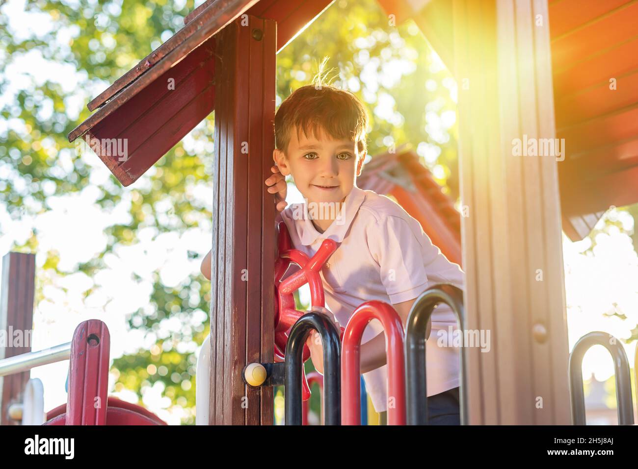 Green-eyed boy smiling while playing in a playground Stock Photo - Alamy