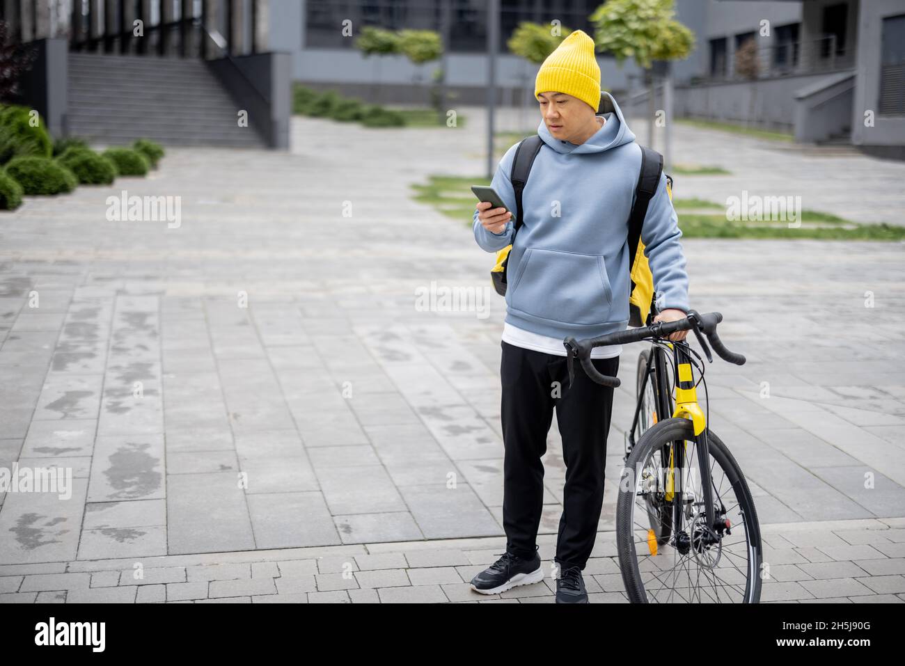 Courier search client place on smartphone in city Stock Photo