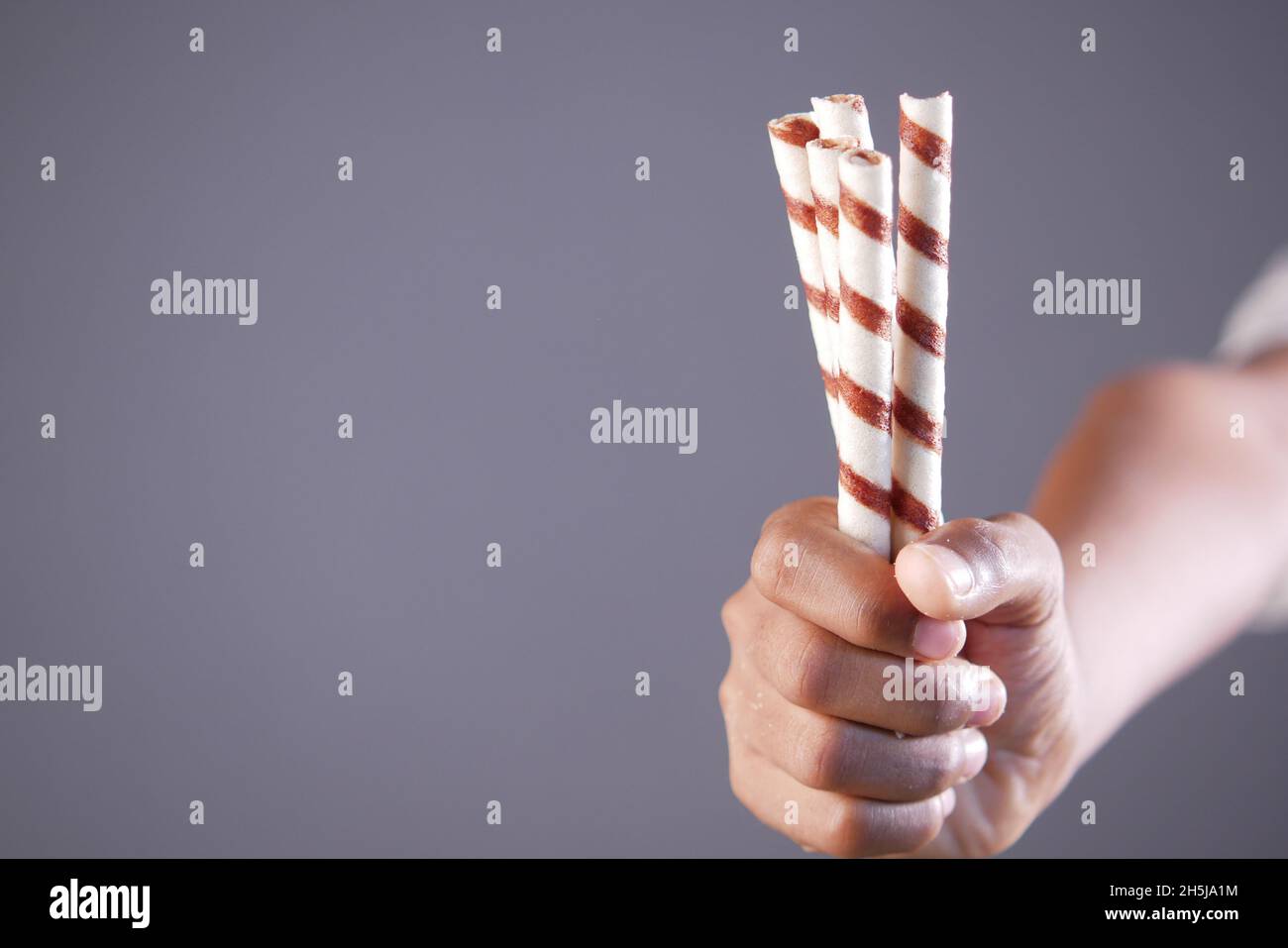 child hand hold chocolate wafer with copy space Stock Photo - Alamy