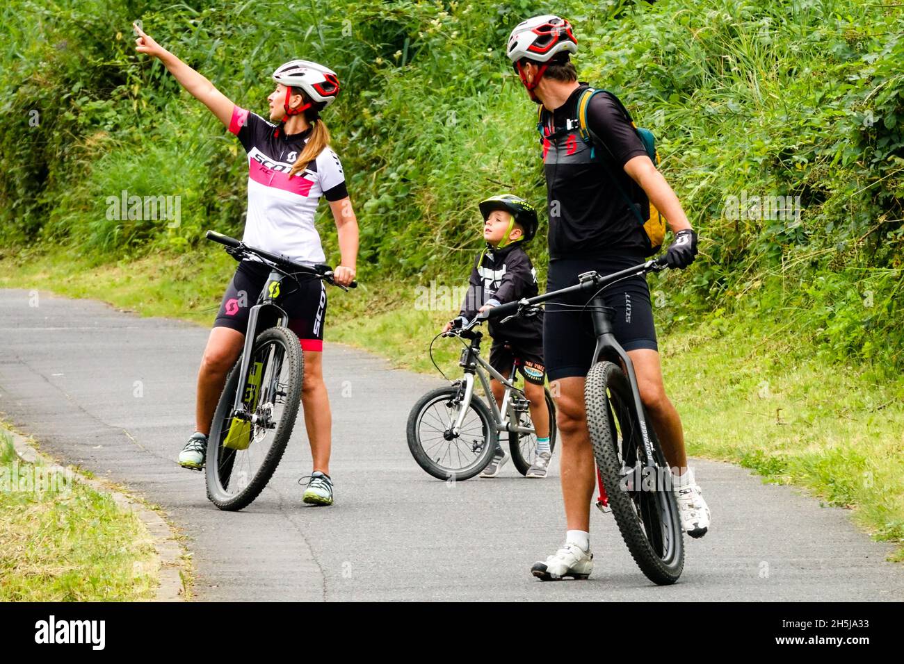 Family on bikes Germany cycle route Child ride a bike in helmet, trail Stock Photo