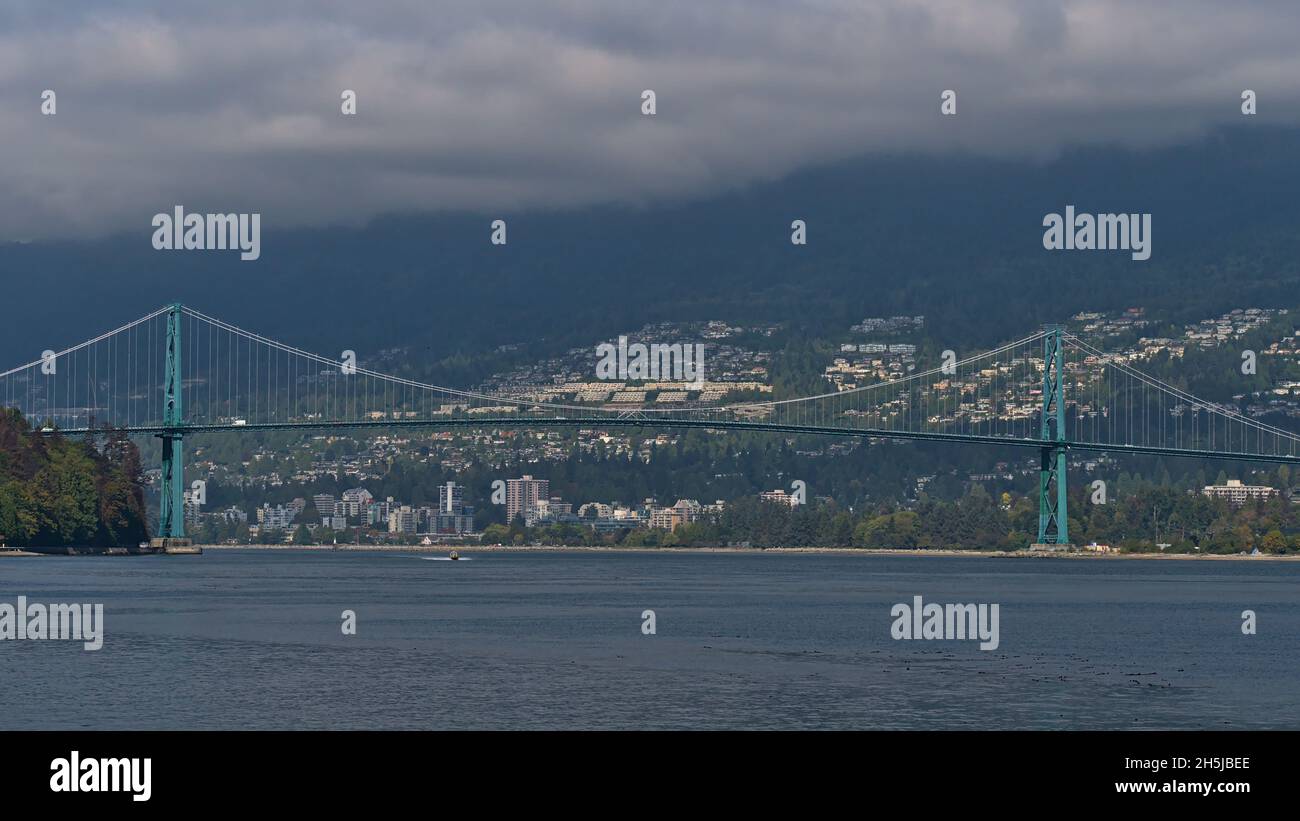 View of Lions Gate Bridge (First Narrows Bridge) crossing Burrard Inlet in Vancouver, British Columbia, Canada with the city of West Vancouver. Stock Photo