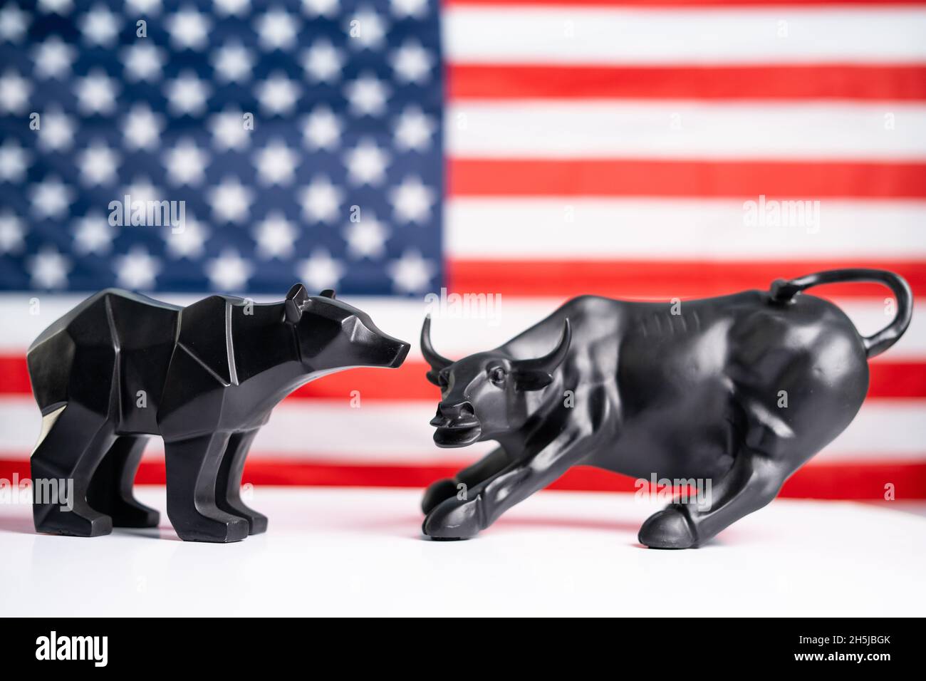 stock market bull and bear with american flag as background - Concept of investment in US equity shares market. Stock Photo
