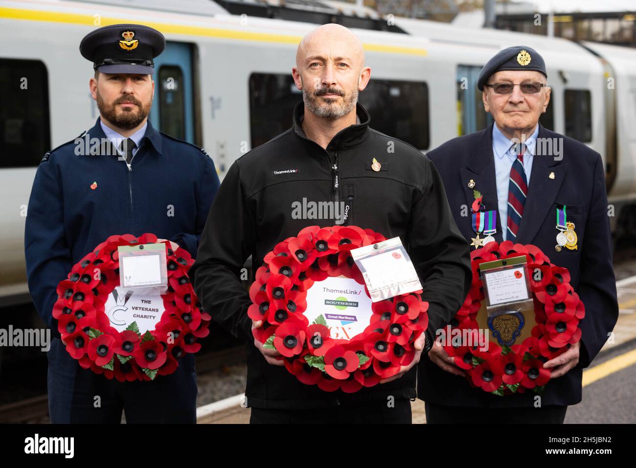 EDITORIAL USE ONLY (Left-right) Oliver Evans from RAF Henlow, Thameslink driver, Noel Hughes and veteran Tony Kemp at Bedford Station before transporting a poppy wreath to London, marking the rail operator's partnership with The Veterans Charity on the nationwide 'Routes of Remembrance' campaign, which sees poppy wreaths touring the country's railway network to Honour the Fallen. Picture date: Wednesday November 10, 2021. Stock Photo